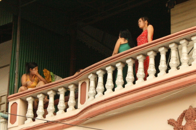 Teenage girls wait for customers at a brothel in Phnom Penh, Cambodia